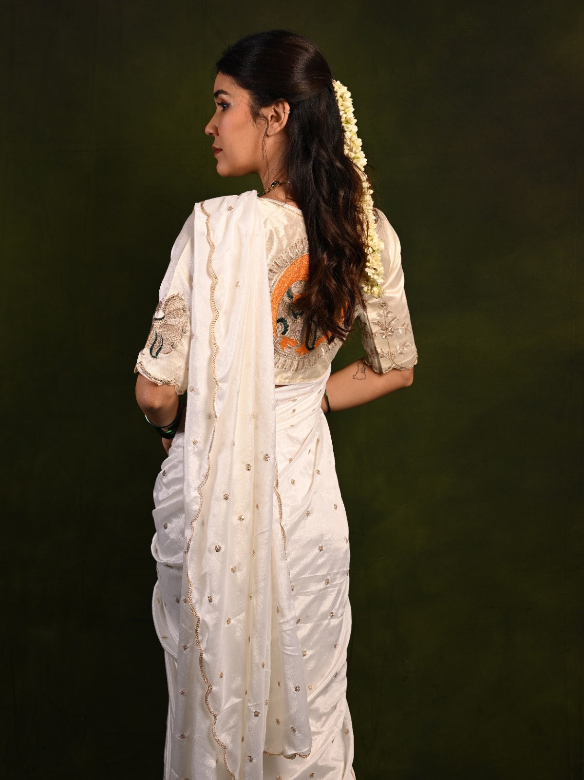 Close-up of sequence work on Chinon saree, showcasing the delicate shine and intricate details.