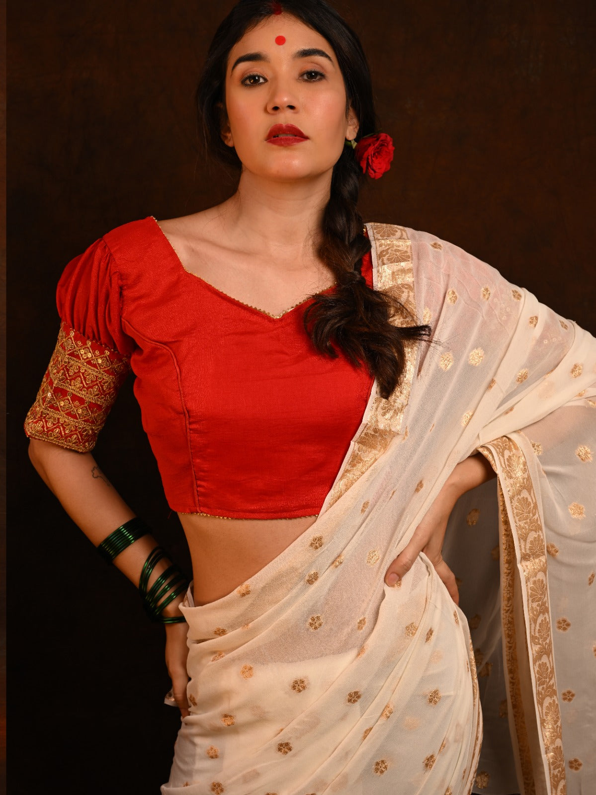Close-up of the intricately embroidered silk blouse, included with the saree.